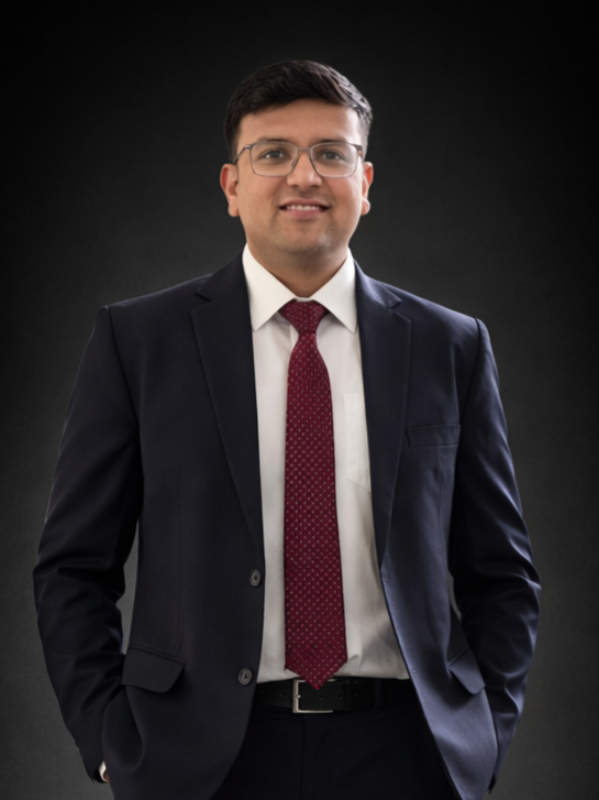 Dr. Vinay Khandelwal standing in a navy suit and burgundy tie